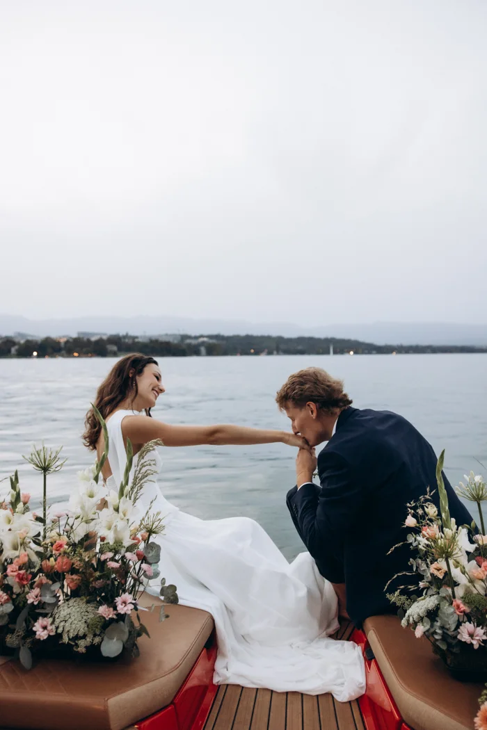 Axel kissing Solenne’s hand on the boat