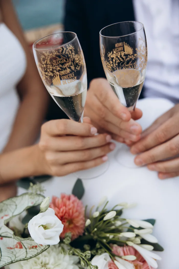 Two glasses of sparkling wine from Cave de Lavaux beside the bouquet