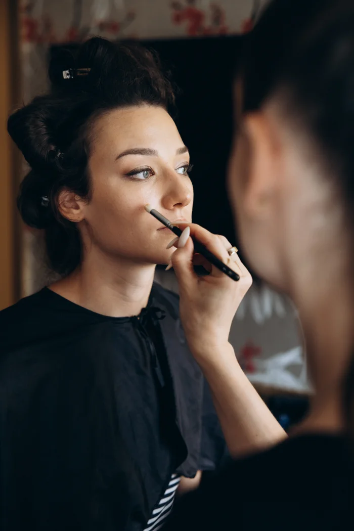 Katya Nyaba doing Solenne’s makeup at Hotel Rotary