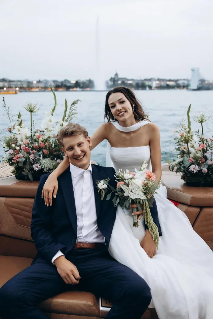Solenne and Axel smiling on the boat among the flowers