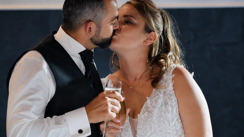 Tiphaine and Nicola kissing during the reception